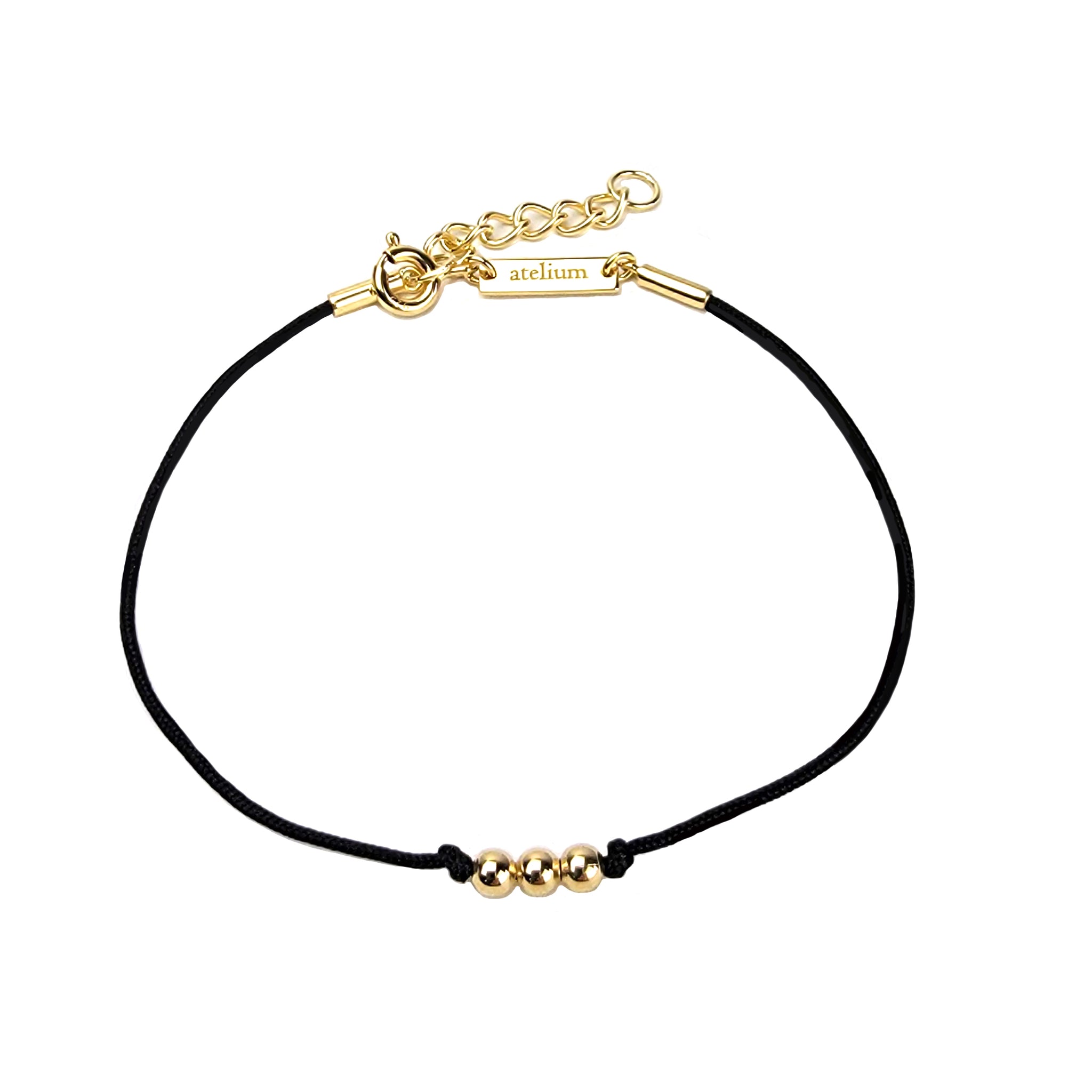 Black string bracelet with 3 gold beads