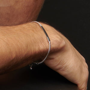 Up close image of a wrist wearing the atelium ID silver bracelet