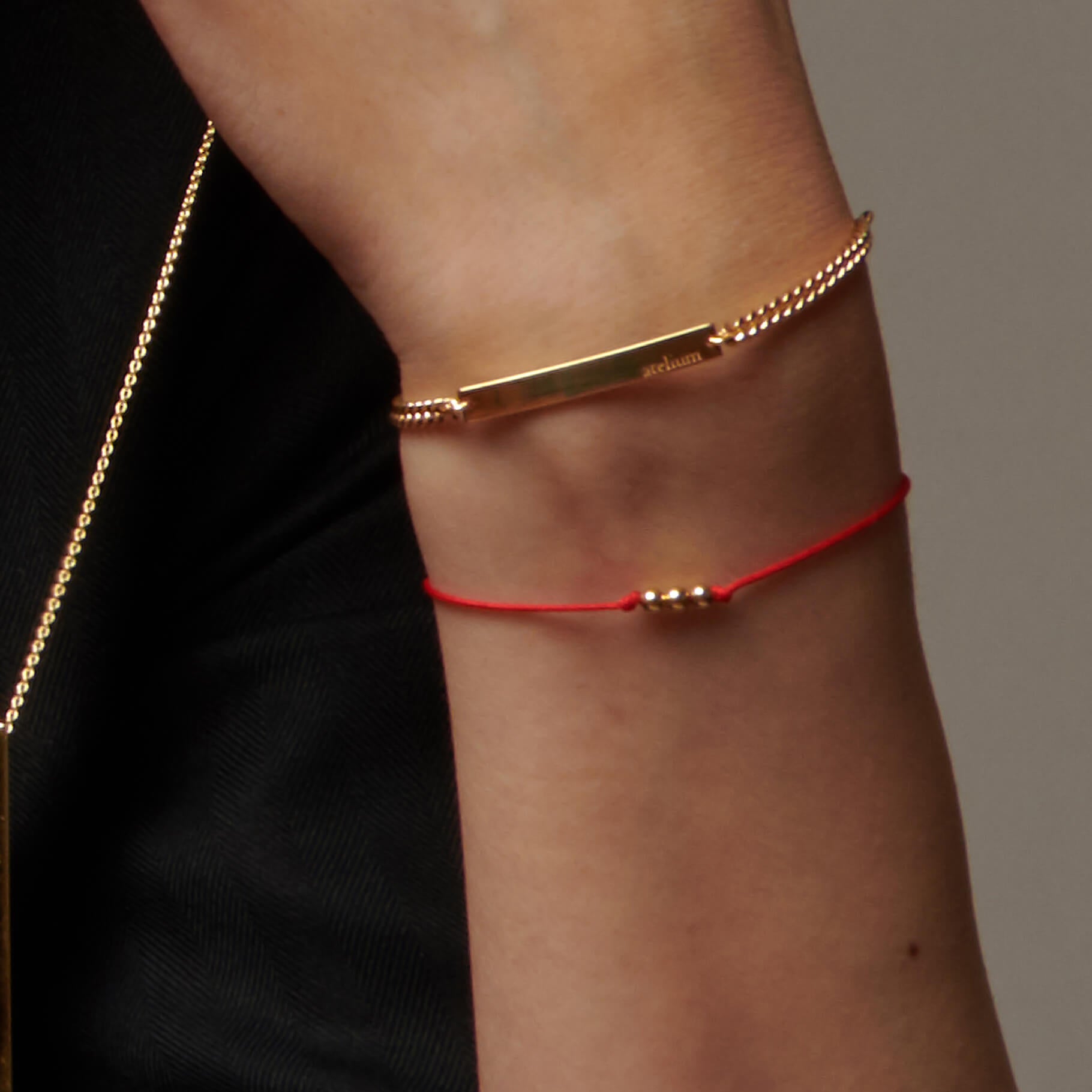 Up close wrist with string bracelets 
