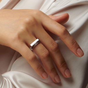 Up close image of hand wearing 2 atelium silver rings