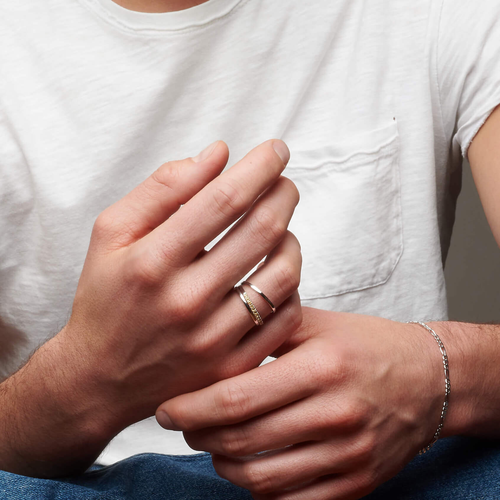 Man's hands with atelium rings and bracelets