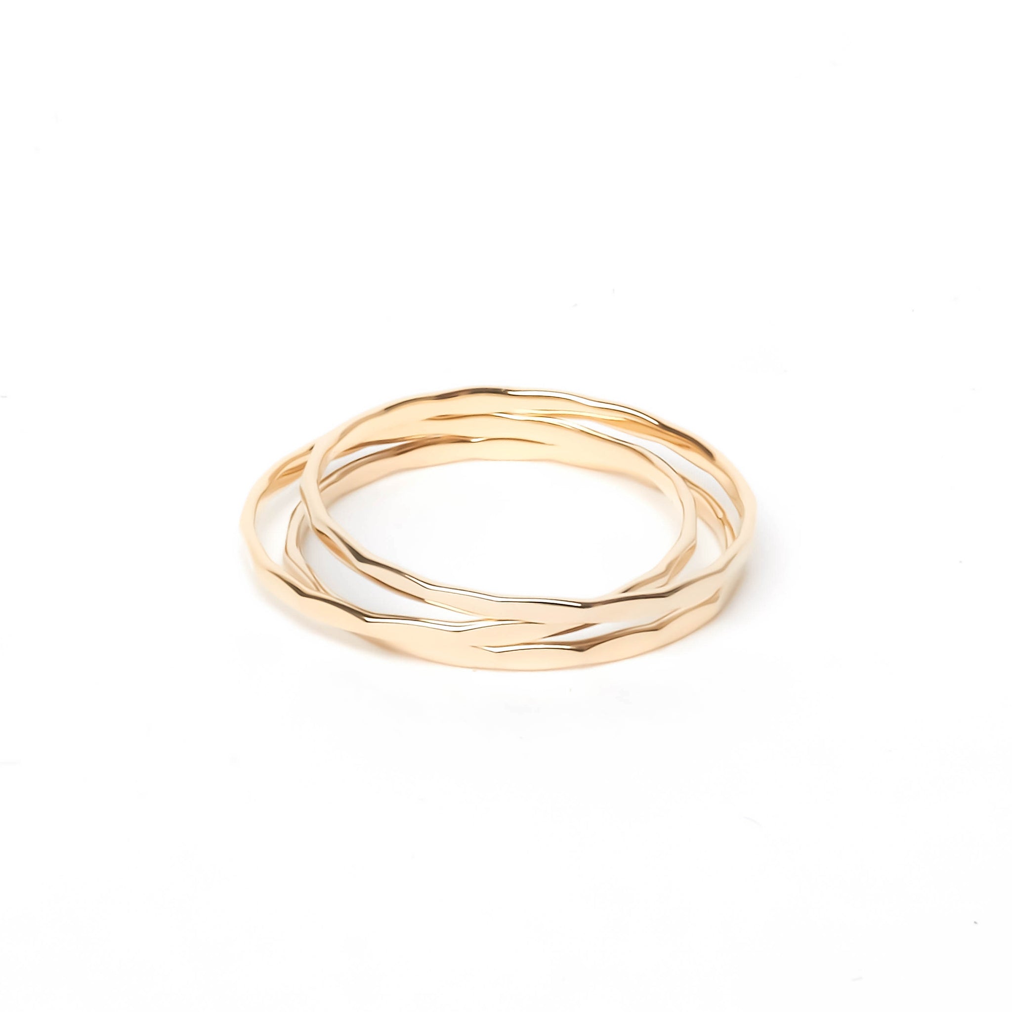 Three gold flat ring with hammered groove decorations stacked