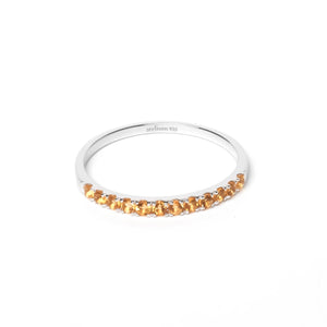 Thin silver ring with multiple citrine gemstones in yellowish orange color