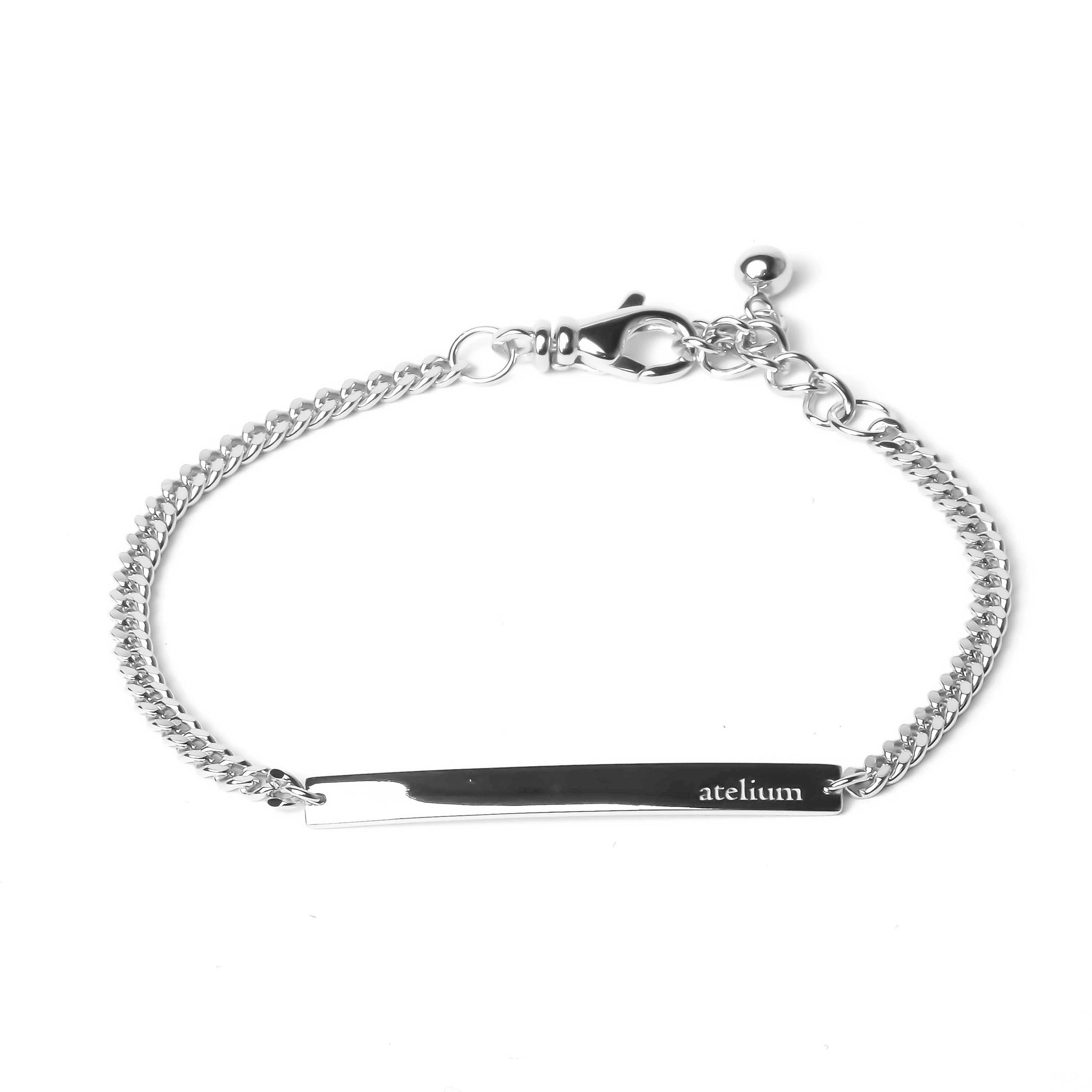 Silver chain bracelet with silver bar in the middle with atelium engraved on it 