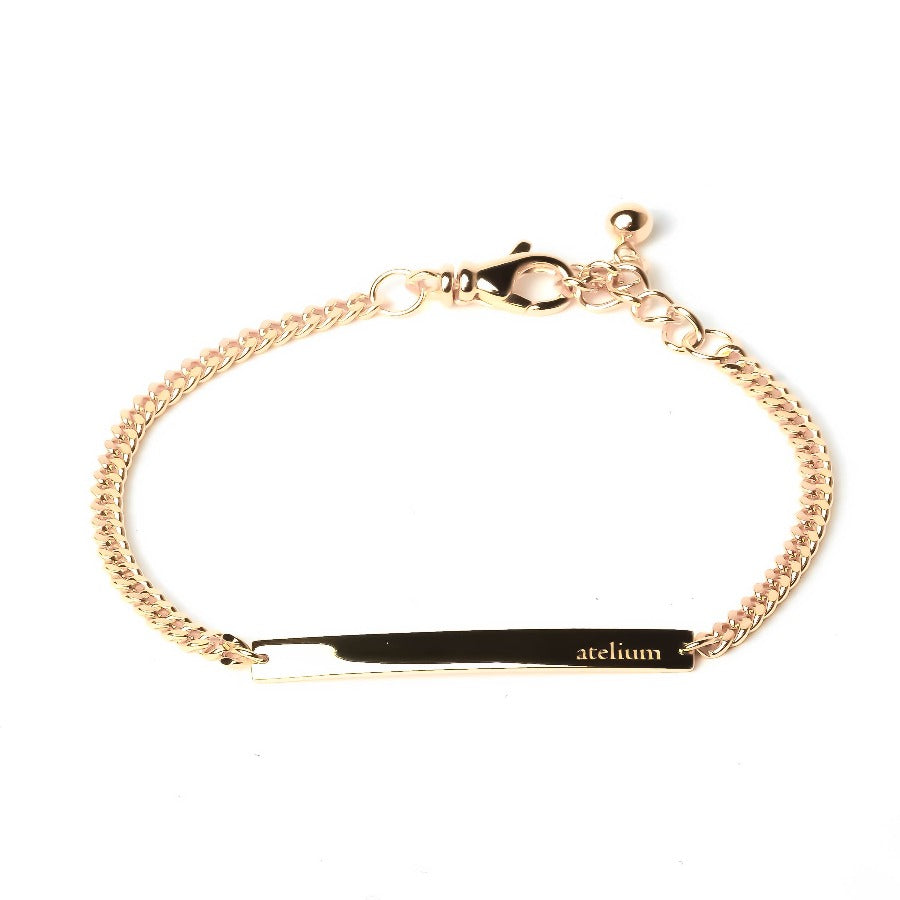 Gold chain bracelet with gold bar with atelium engraved on it