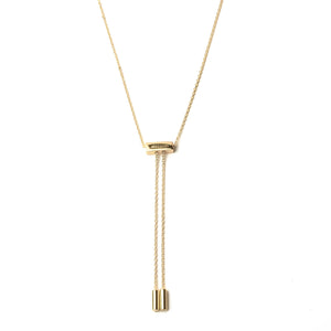 Back side of gold atelium tassel necklace with adjustable pull closure with the 2 ends of the necklace dangling 